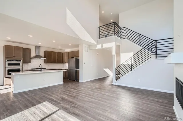 a kitchen with stainless steel appliances a refrigerator and a stove top oven