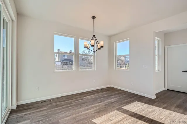 a view of a room window and wooden floor
