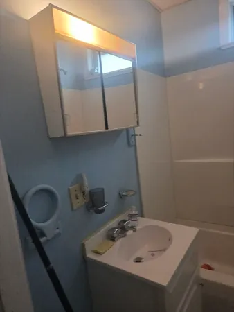 a bathroom with a sink and a mirror