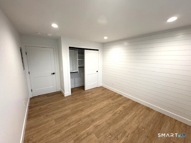 25 Church Street, Unit 301 New Milford, CT 06776 - Photo 9 of 14 wooden floor in an empty room with a window