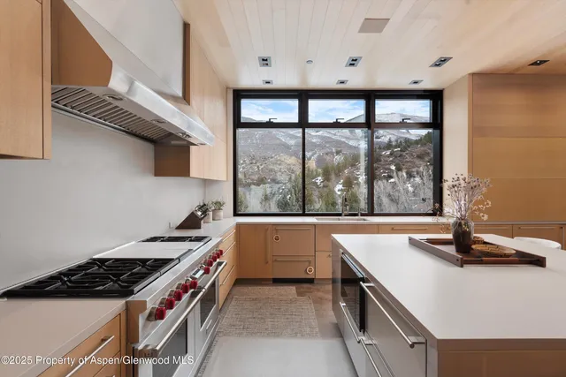 a kitchen with stainless steel appliances and refrigerator
