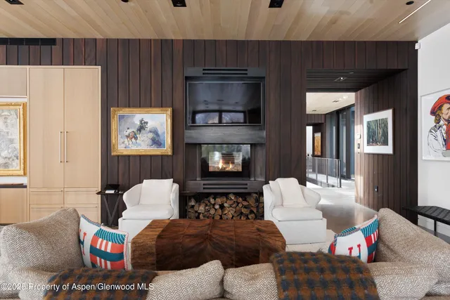 a view of a hallway with furniture and chandelier