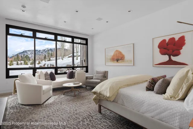 a work room with furniture and a large window