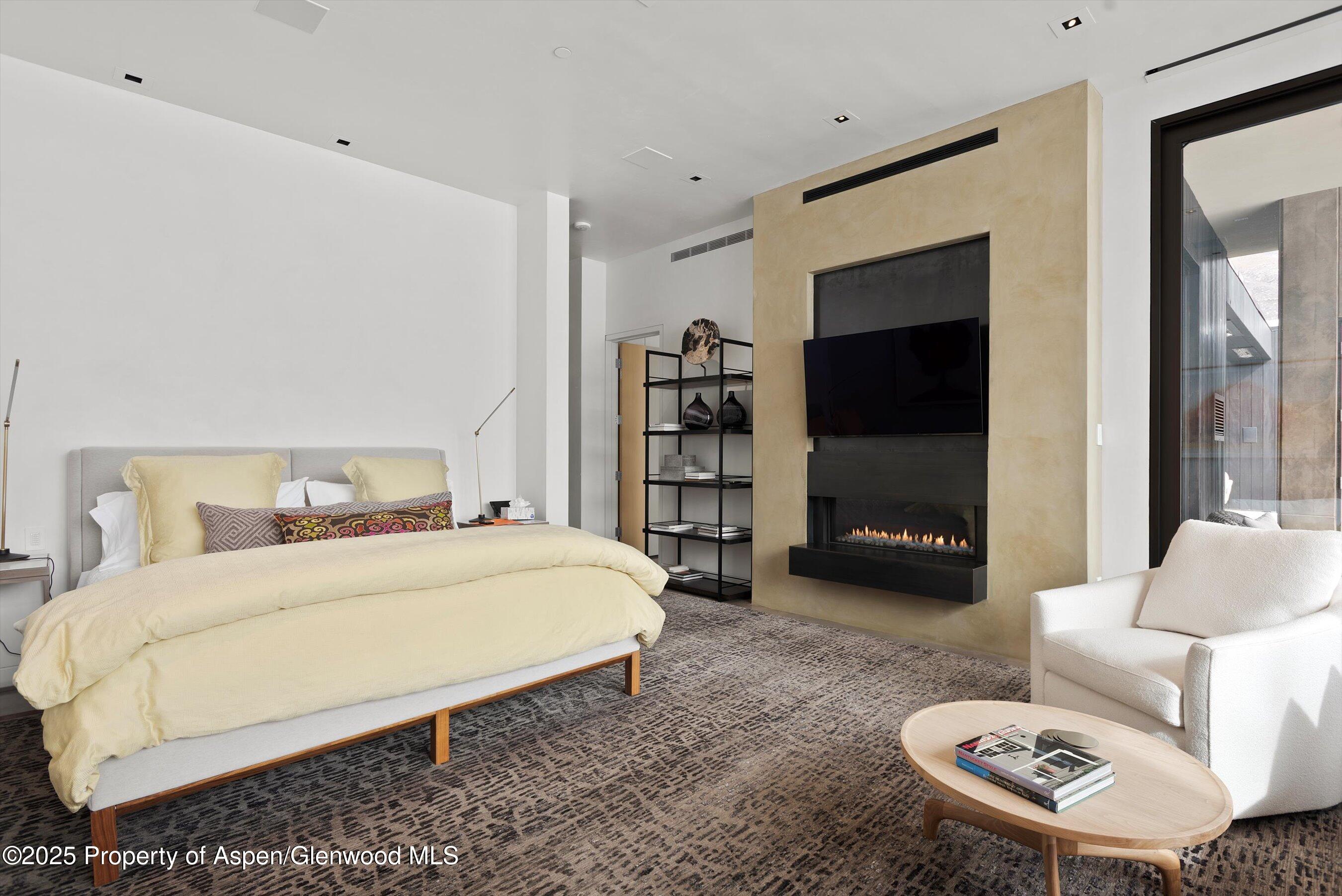 276 Coach Road Aspen, CO 81611 - Photo 19 of 54 a bedroom with a bed a couch and a large window