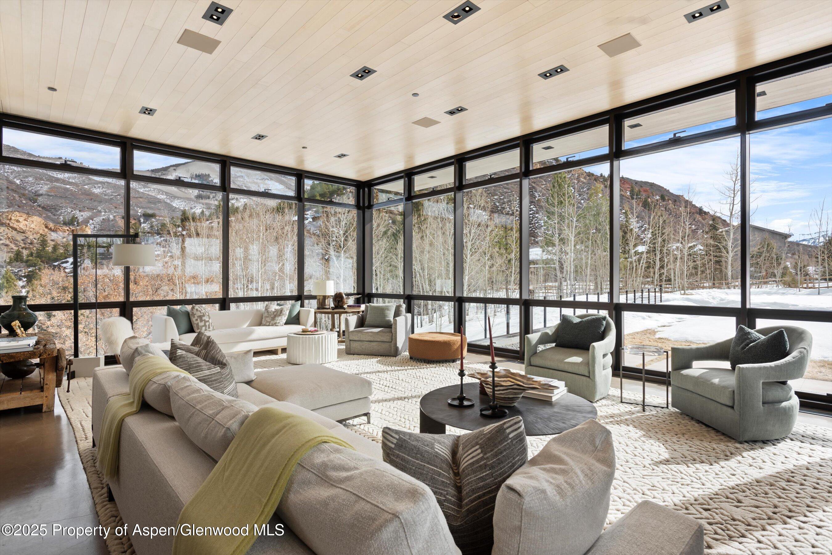 276 Coach Road Aspen, CO 81611 - Photo 3 of 54 a living room with furniture and a floor to ceiling window