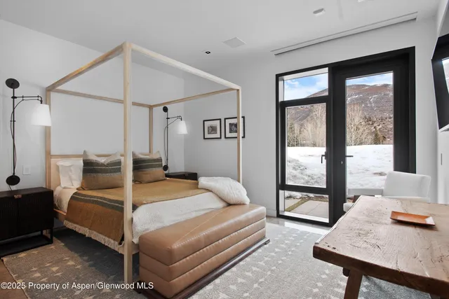 a bedroom with a bed and a mirror