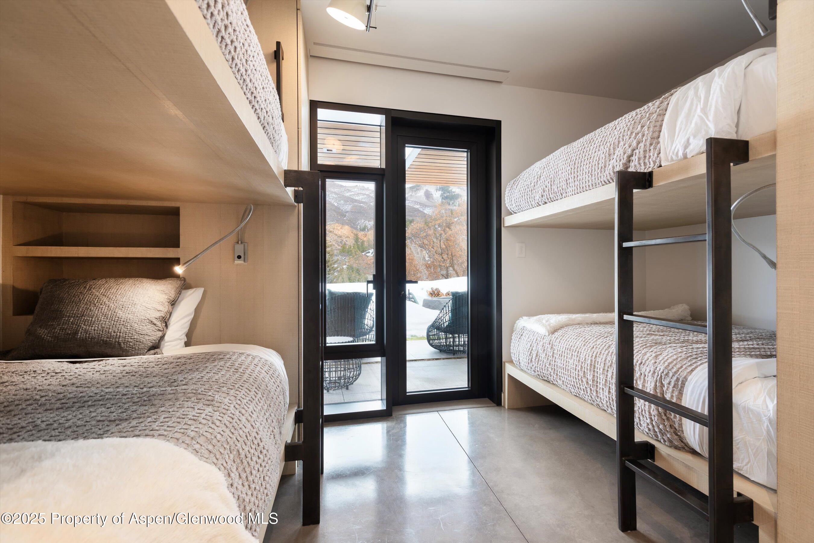 276 Coach Road Aspen, CO 81611 - Photo 35 of 54 a bedroom with a bed and a mirror