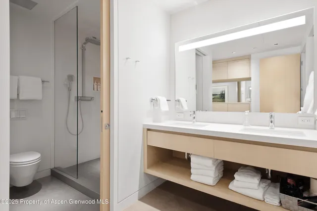 a bathroom with a shower sink and mirror