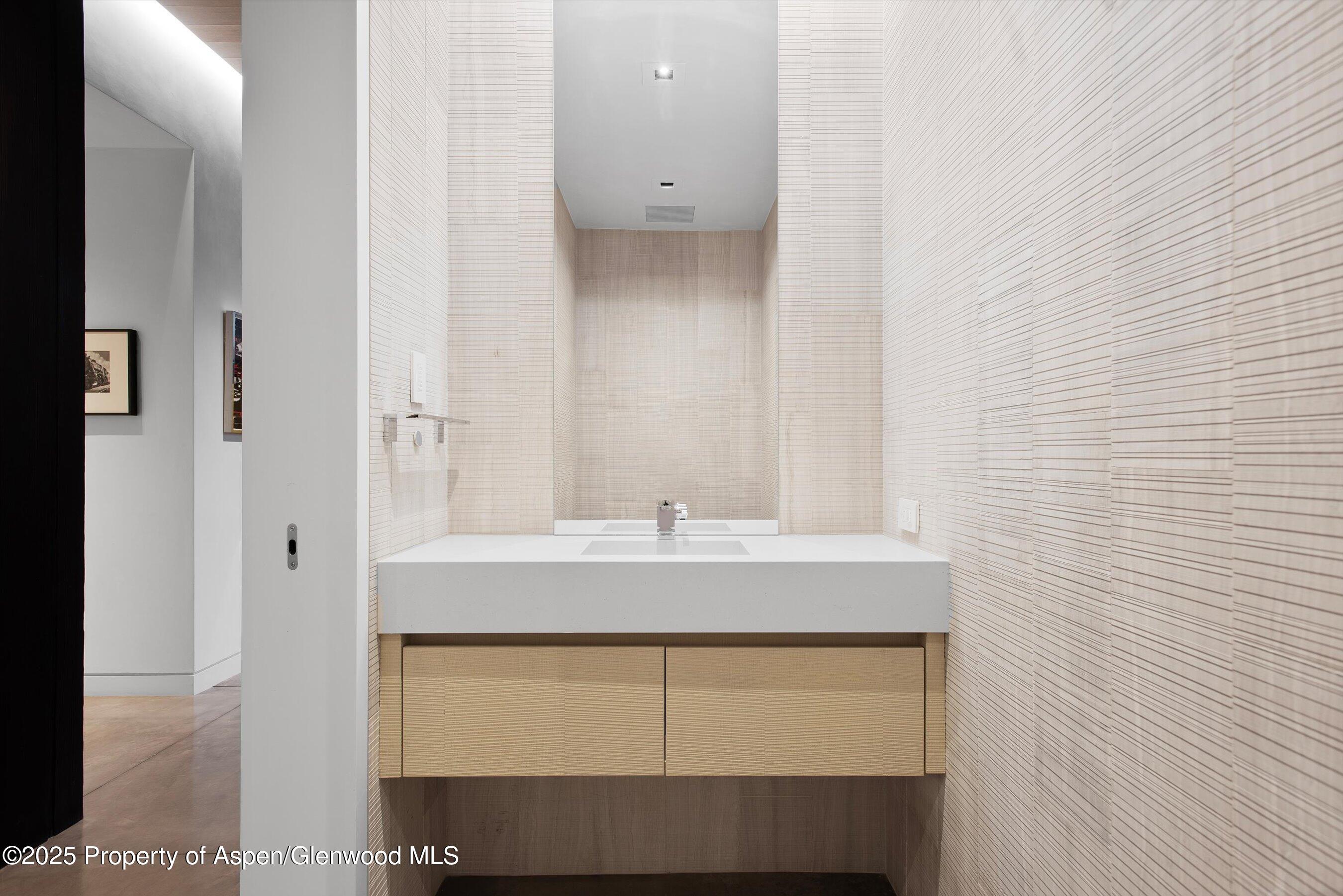 276 Coach Road Aspen, CO 81611 - Photo 37 of 54 a bathroom with a sink and a mirror