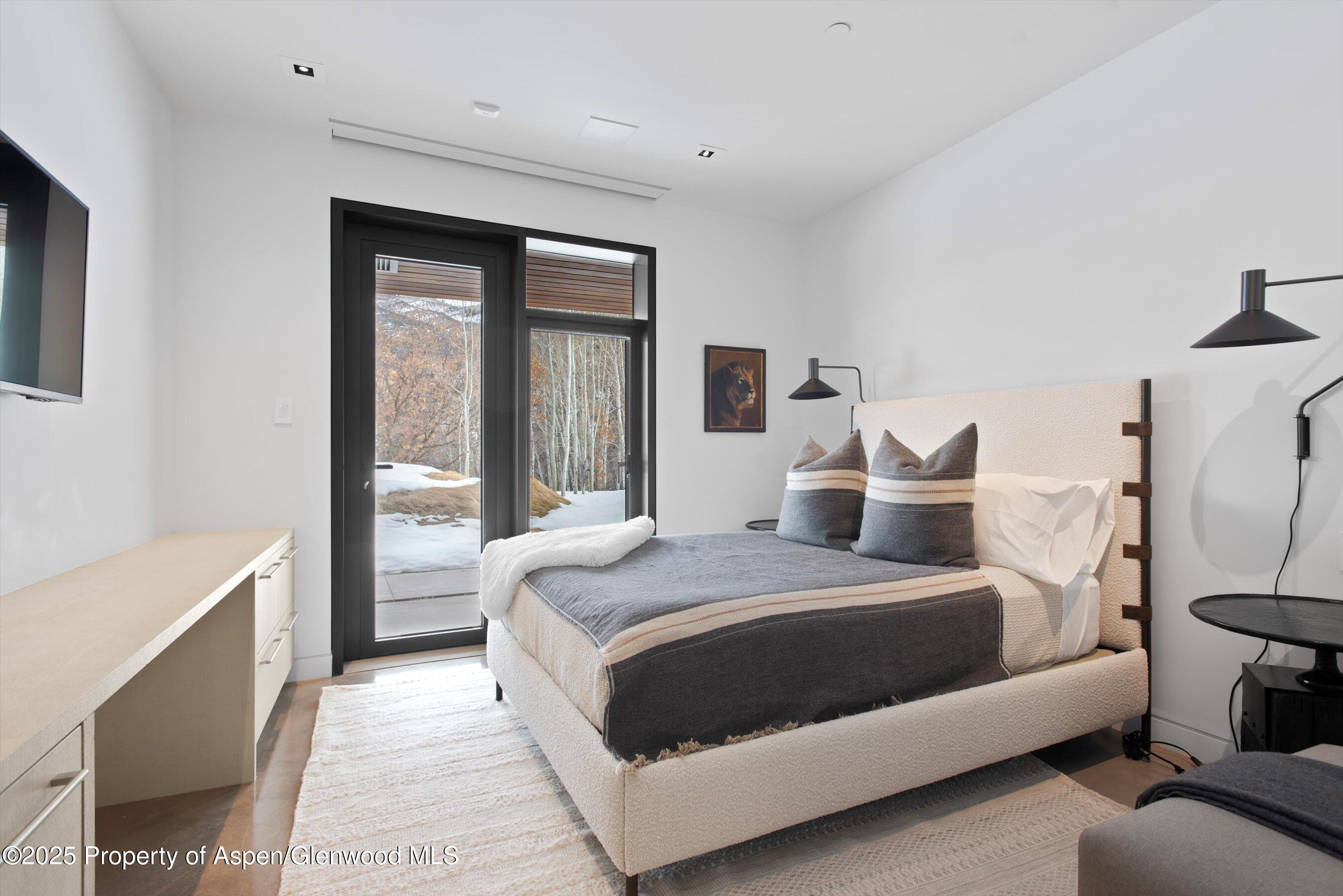 276 Coach Road Aspen, CO 81611 - Photo 38 of 54 a bedroom with a bed and a large window