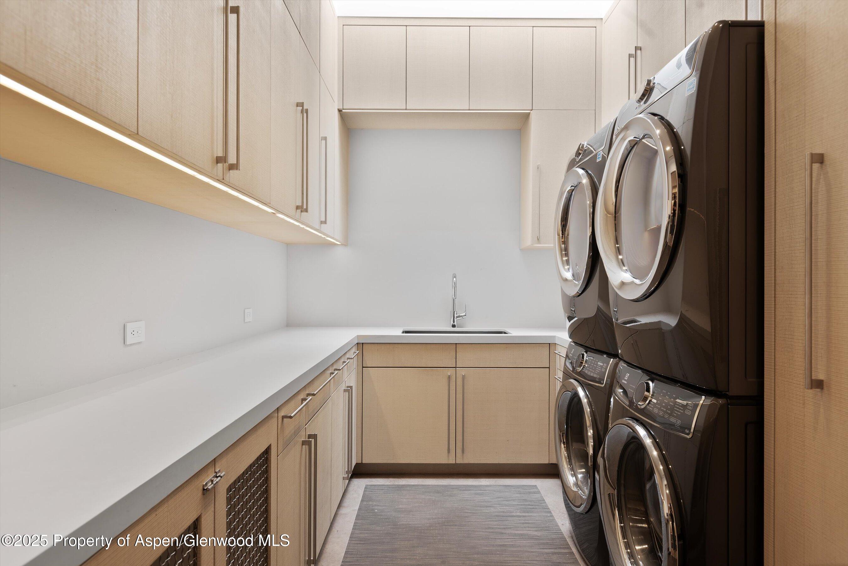 276 Coach Road Aspen, CO 81611 - Photo 42 of 54 a utility room with sink dryer and washer