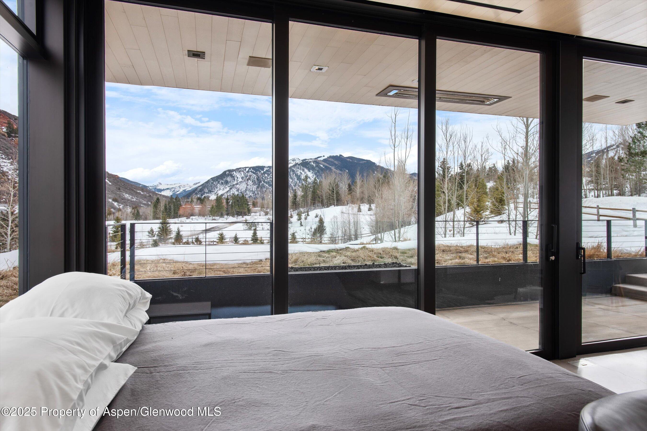 276 Coach Road Aspen, CO 81611 - Photo 51 of 54 a bedroom with a large window and a bed