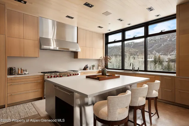 a kitchen with a stove and a white refrigerator