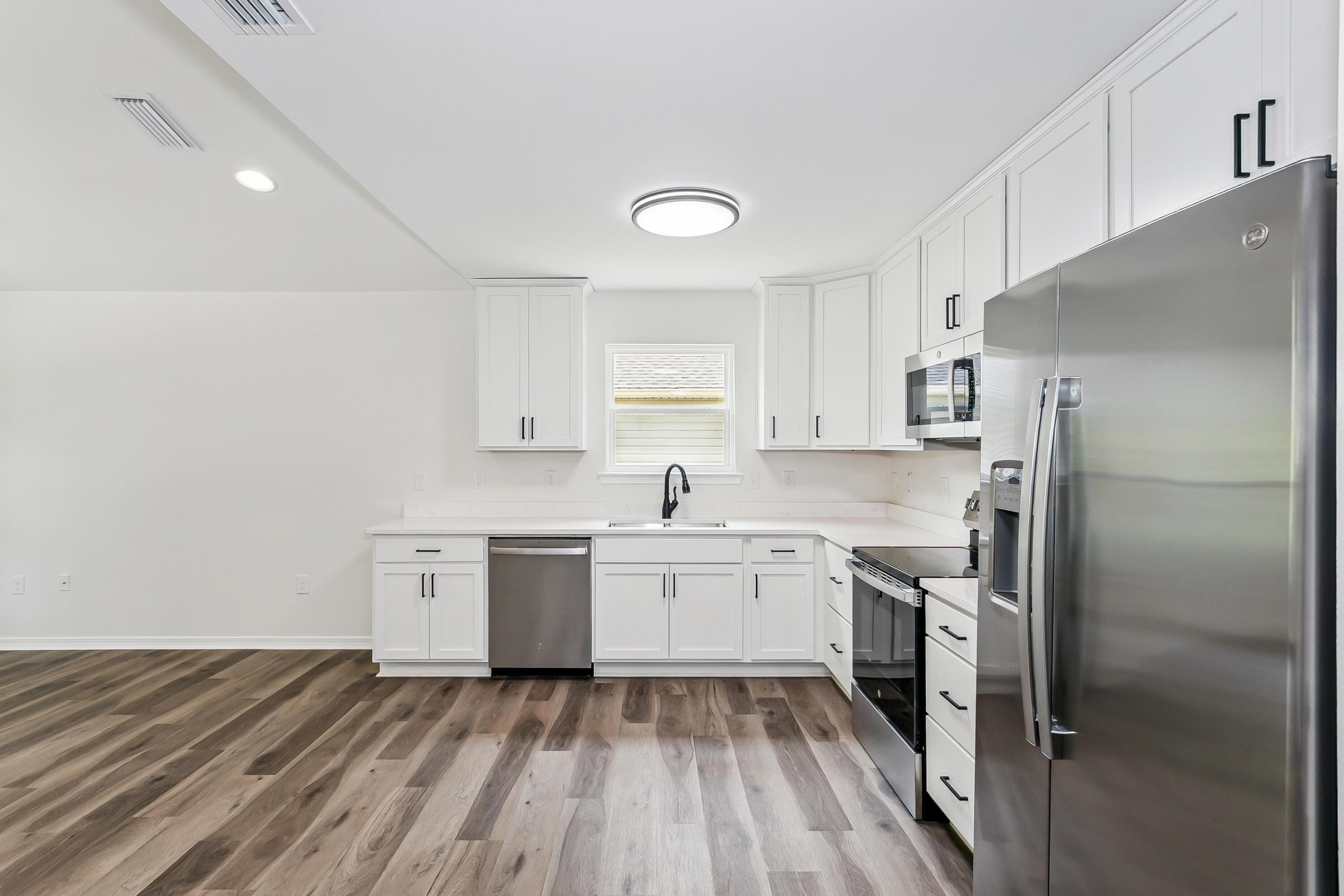 8084 3rd Street Laurel Hill, FL 32567 - Photo 12 of 34 a kitchen with a sink stove and refrigerator