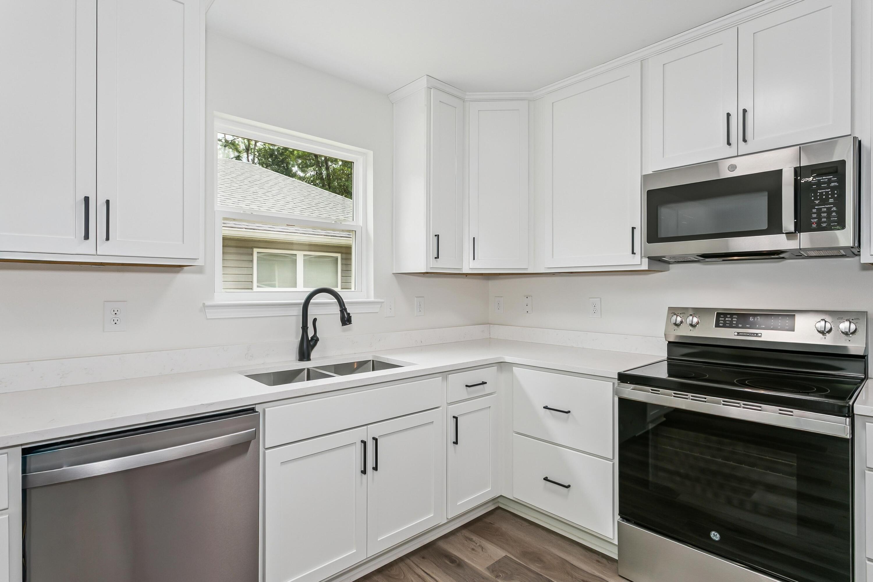 8084 3rd Street Laurel Hill, FL 32567 - Photo 13 of 34 a kitchen with cabinets stainless steel appliances and a window