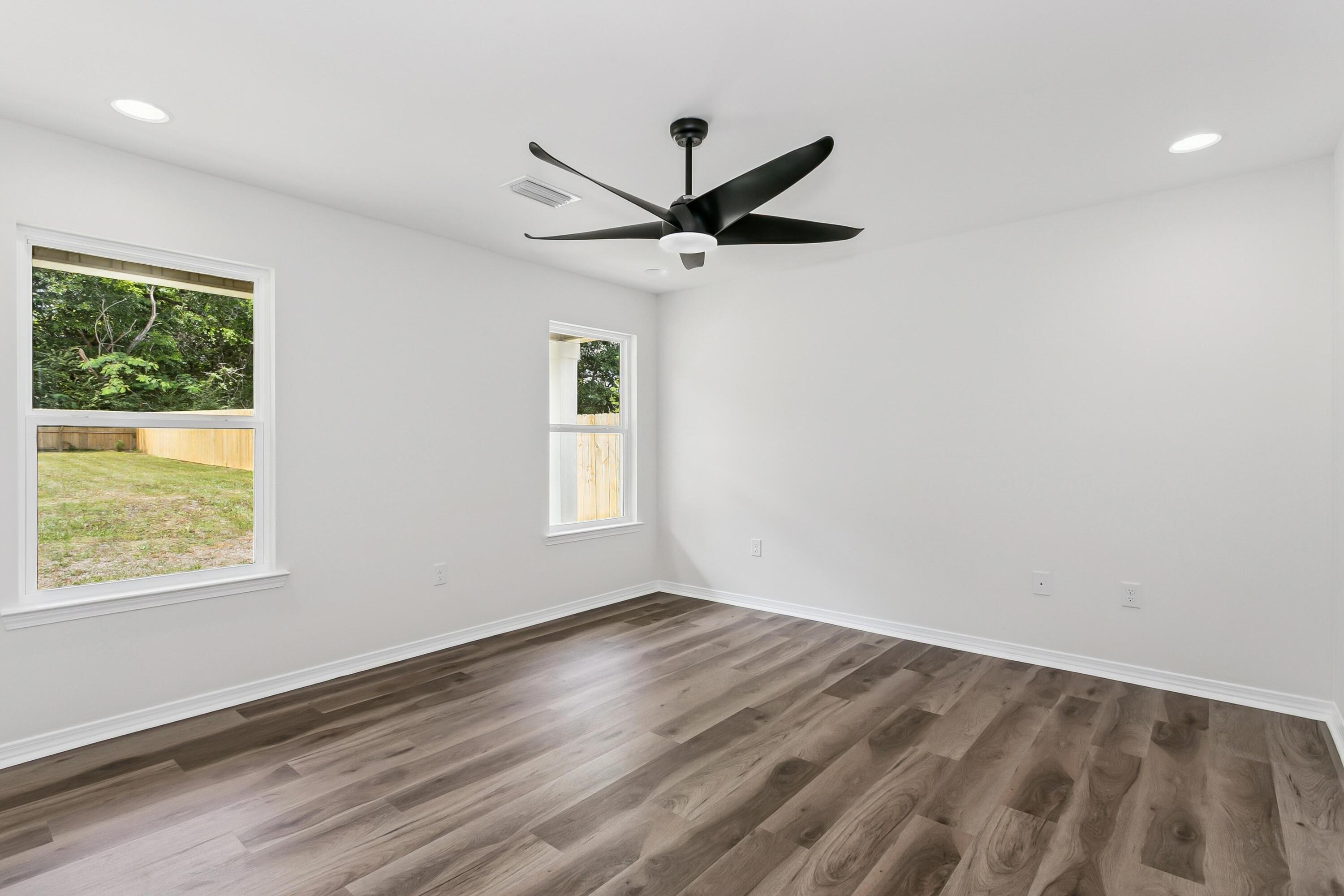 8084 3rd Street Laurel Hill, FL 32567 - Photo 17 of 34 a view of empty room with wooden floor and fan