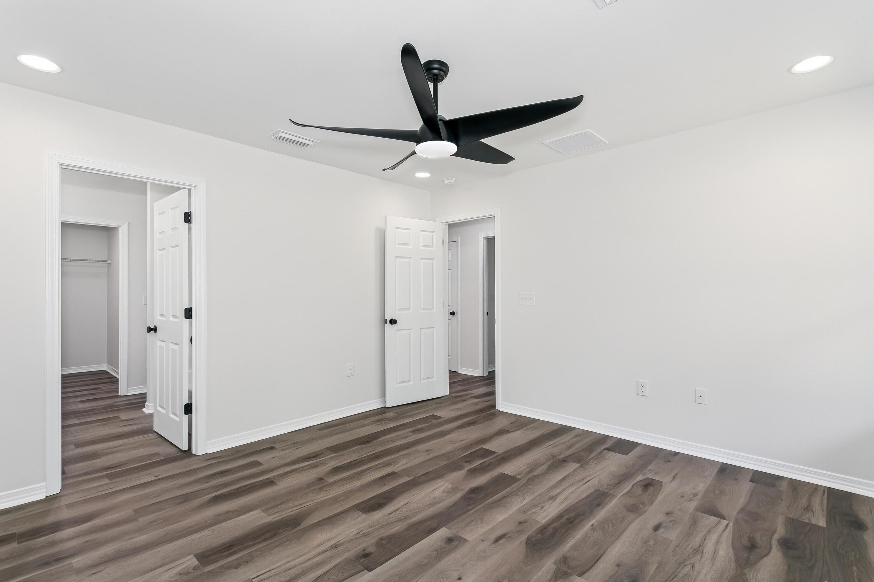 8084 3rd Street Laurel Hill, FL 32567 - Photo 18 of 34 wooden floor in an empty room