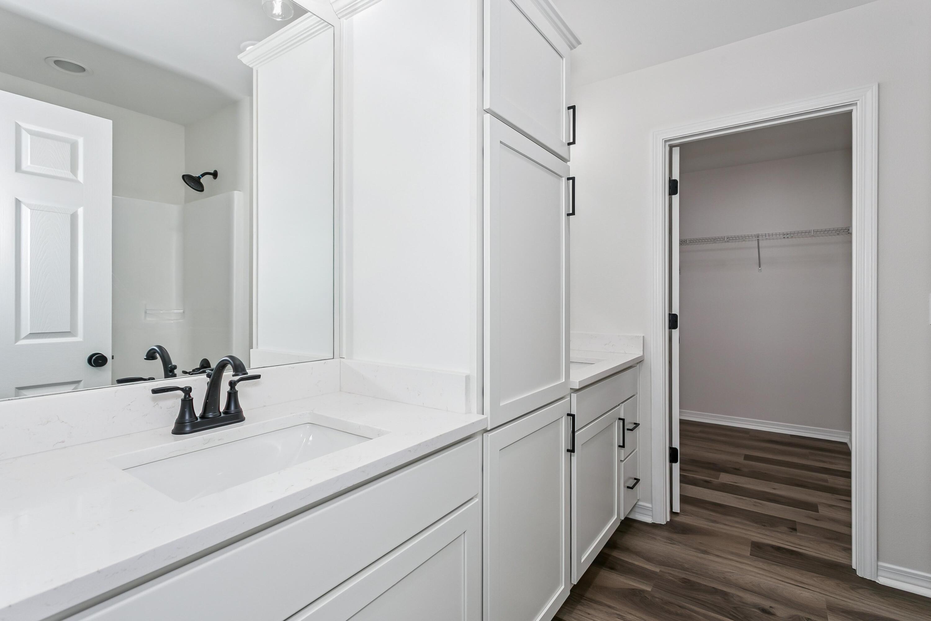 8084 3rd Street Laurel Hill, FL 32567 - Photo 21 of 34 a bathroom with double vanity sink and mirror