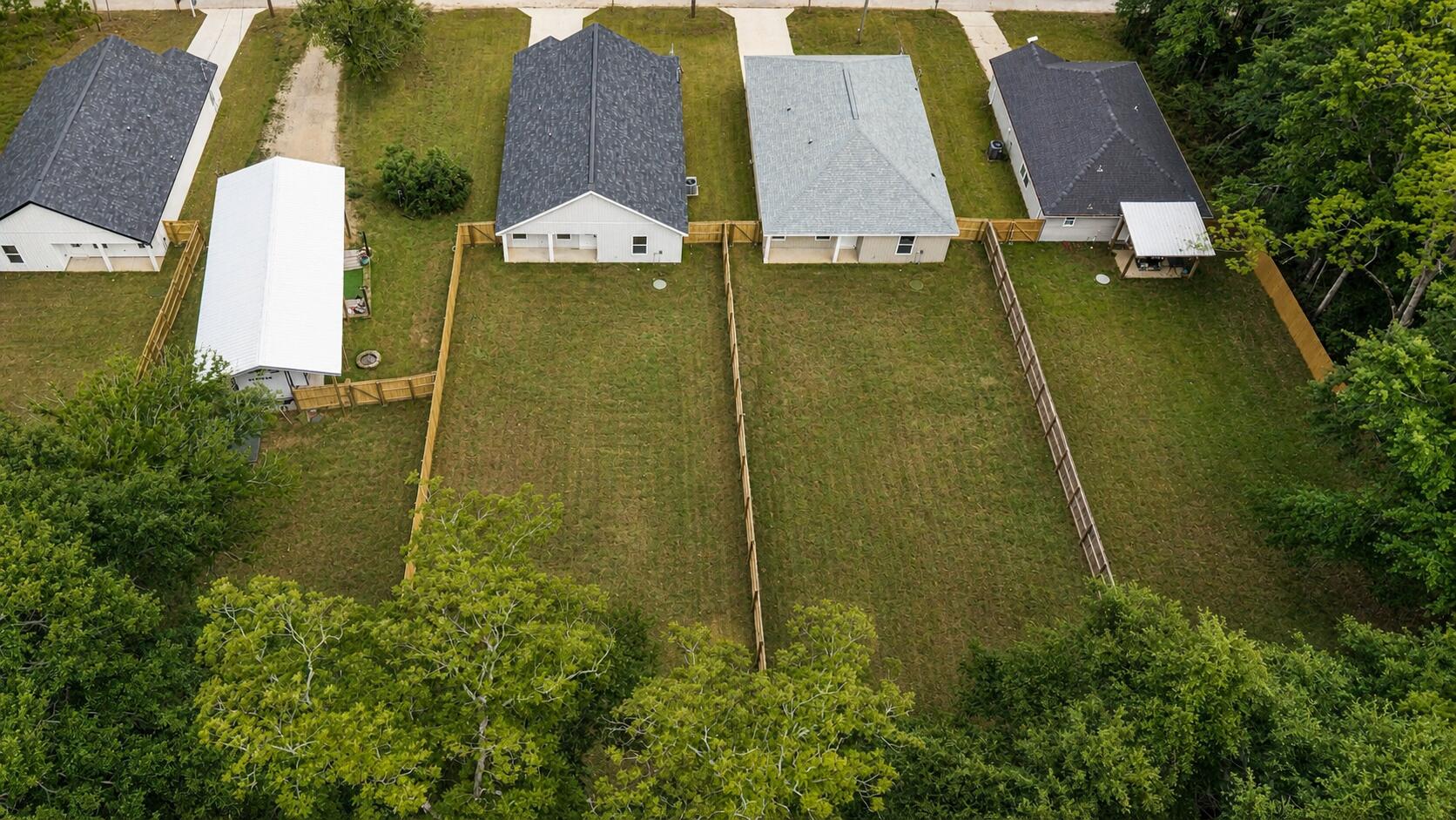 8084 3rd Street Laurel Hill, FL 32567 - Photo 32 of 34 an aerial view of residential houses with outdoor space and trees