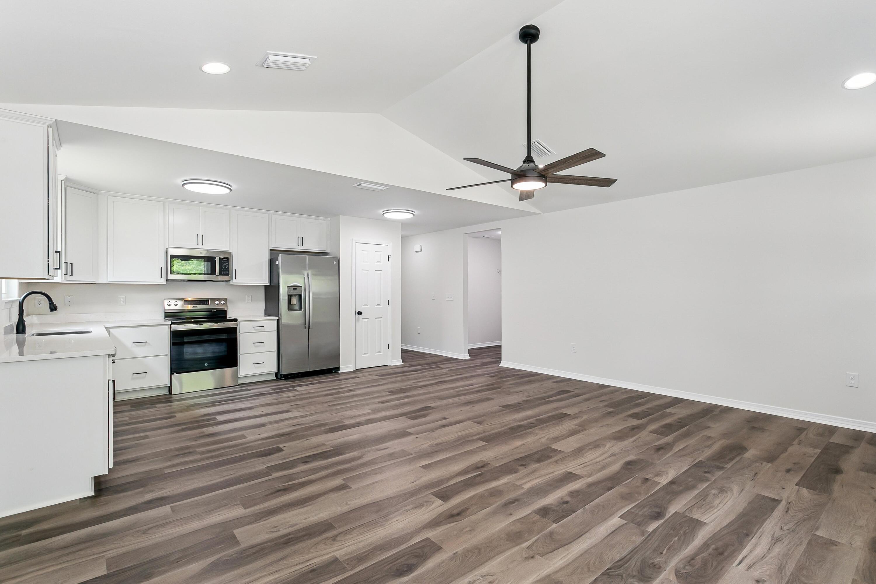 8084 3rd Street Laurel Hill, FL 32567 - Photo 10 of 34 a view of a kitchen with a sink stainless steel appliances and cabinets