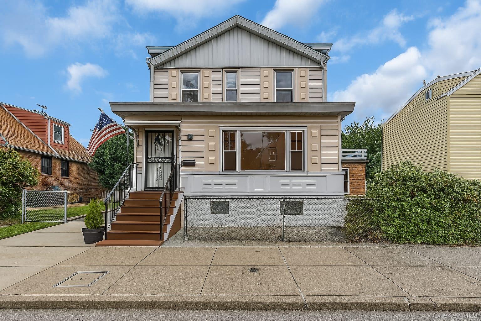 91-15 79th Street Queens, NY 11421 - Photo 1 of 12 a front view of a house with garage