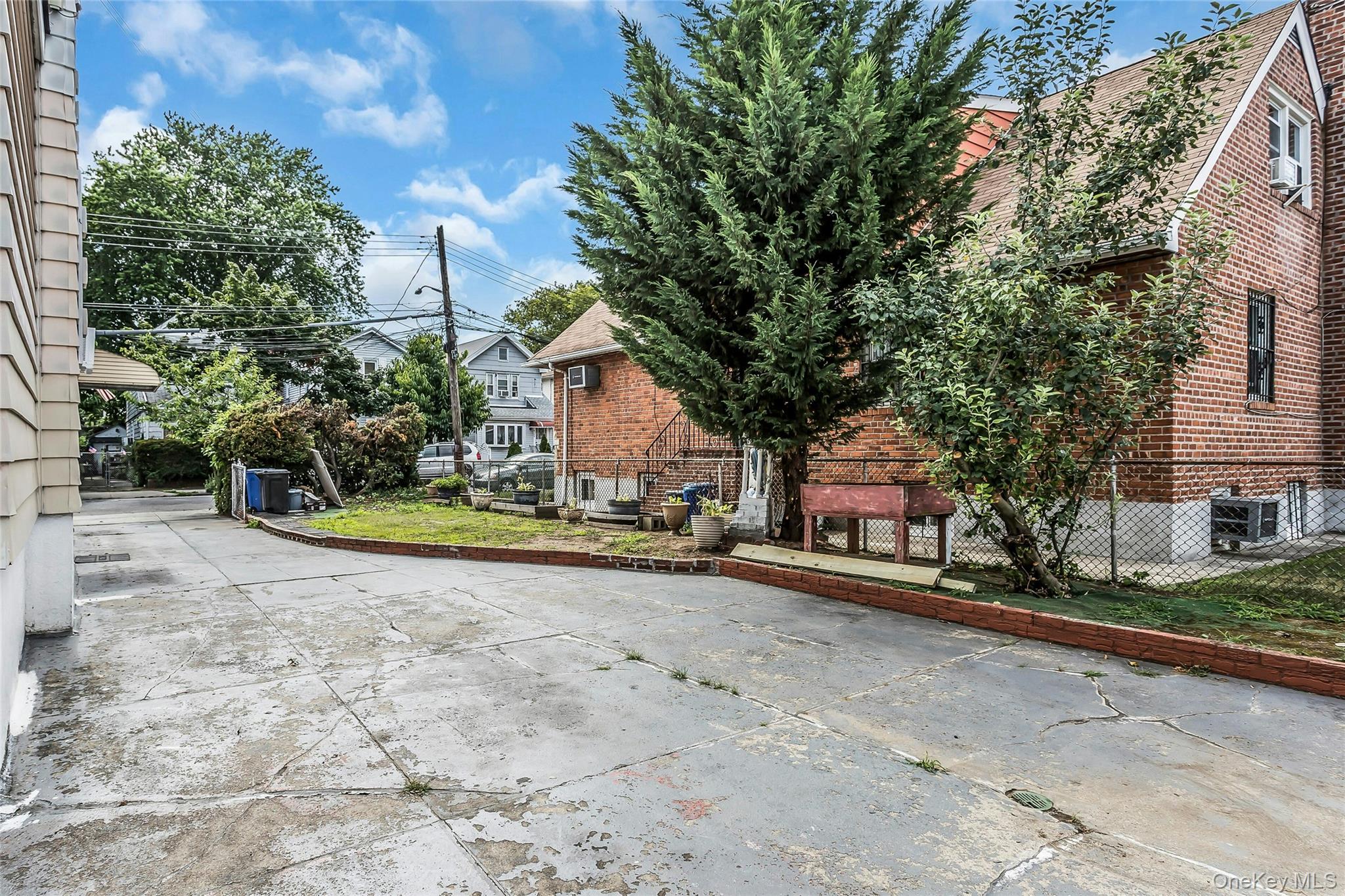 91-15 79th Street Queens, NY 11421 - Photo 11 of 12 a view of a house with a yard and large tree