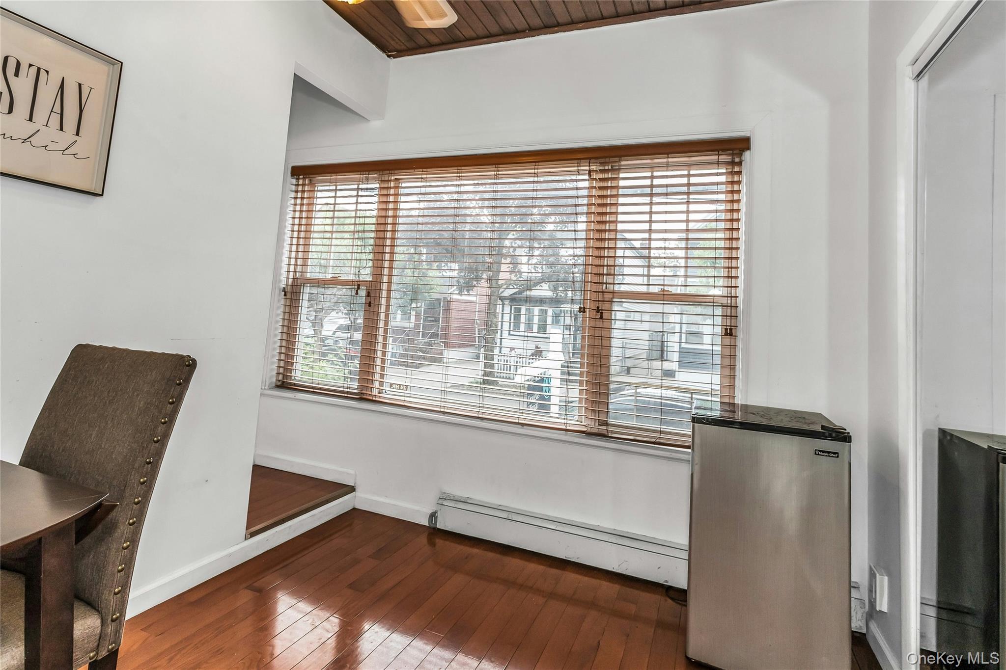 91-15 79th Street Queens, NY 11421 - Photo 6 of 12 a view of an empty room with a window