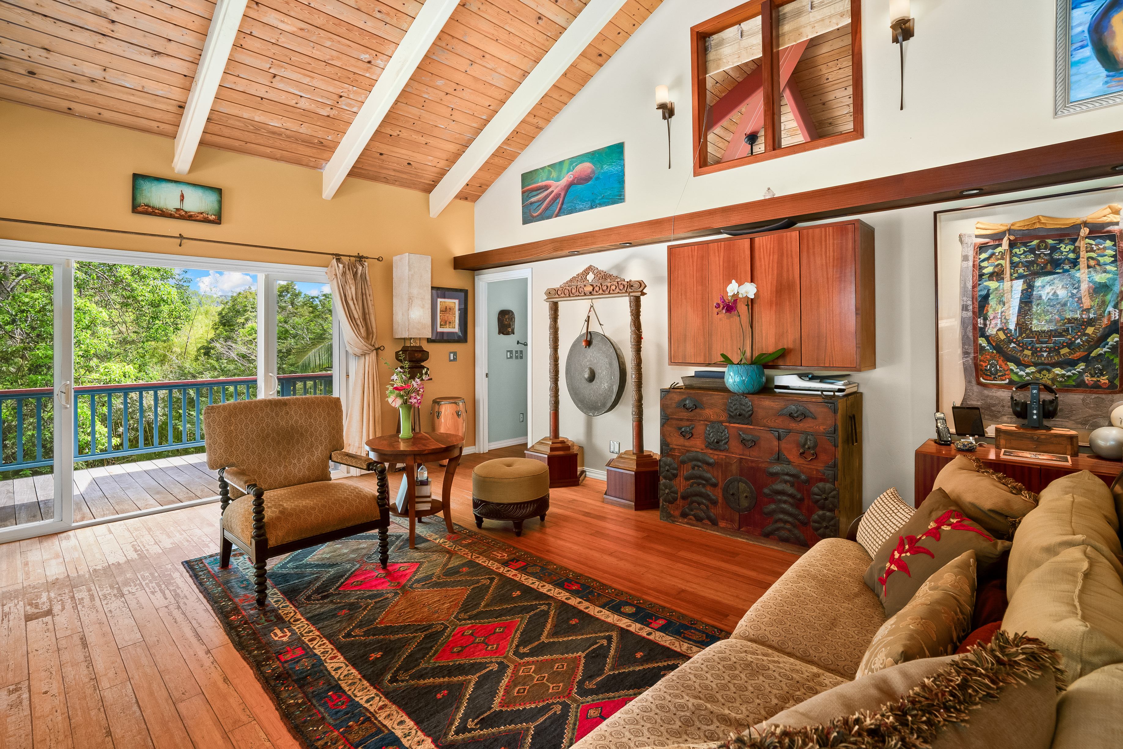 5728 Olohena Road Kapaa, HI 96746 - Photo 3 of 30 a living room with furniture a fireplace and a floor to ceiling window