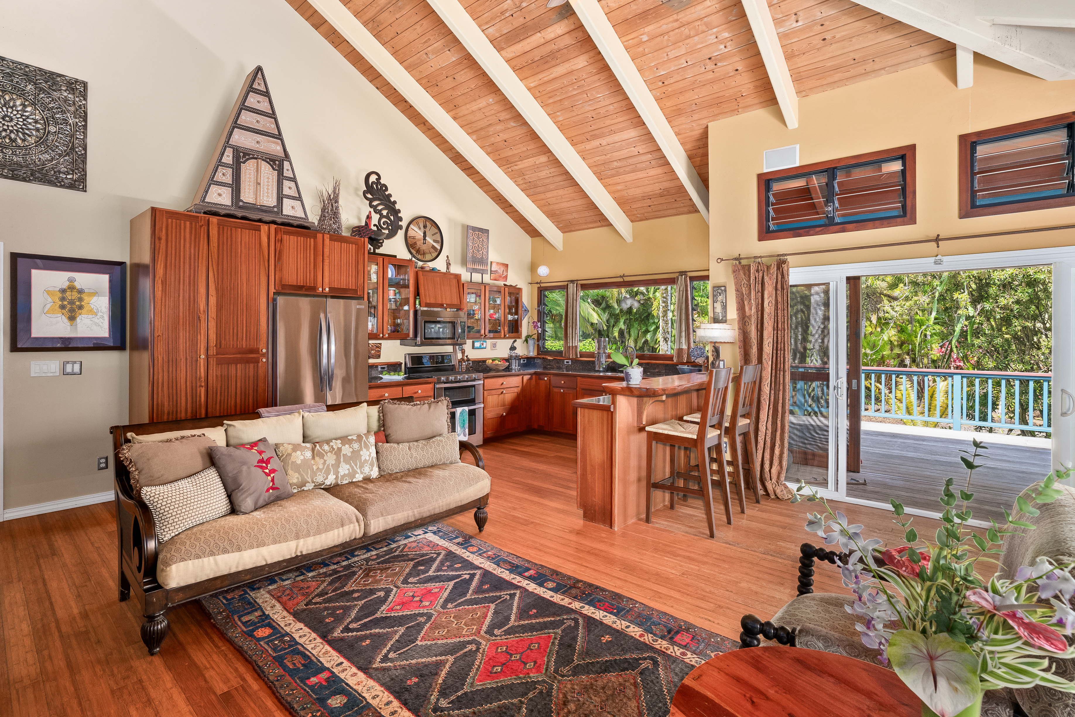 5728 Olohena Road Kapaa, HI 96746 - Photo 6 of 30 a living room with furniture a fireplace and wooden floor