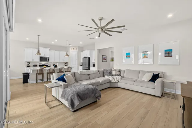 a living room with furniture and kitchen view