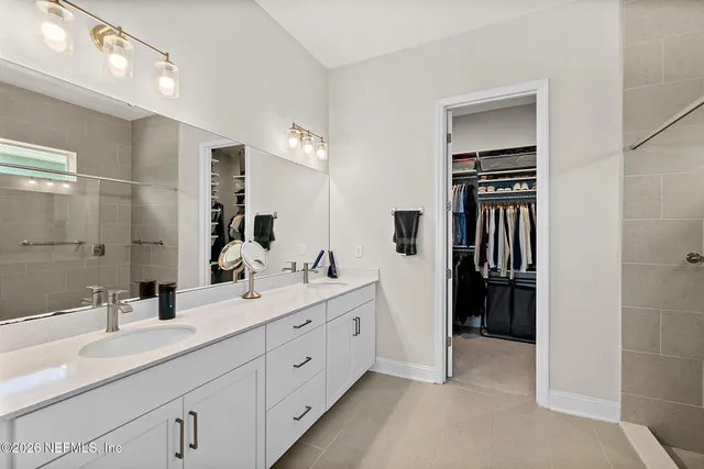 a en suite bathroom with double sink and mirror