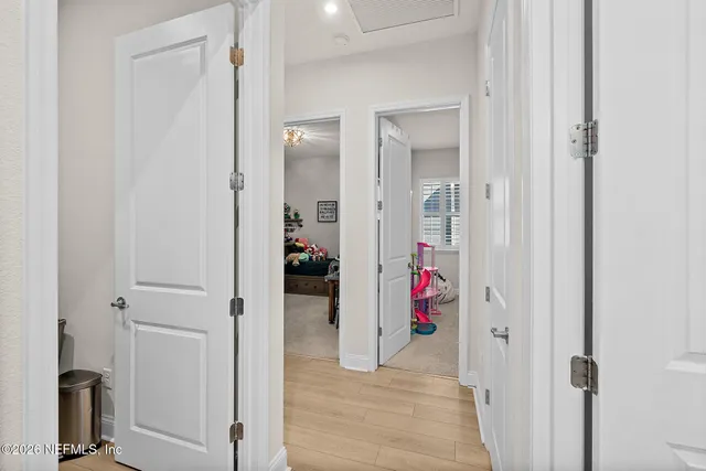 a view of a hallway with closet and a livingroom view