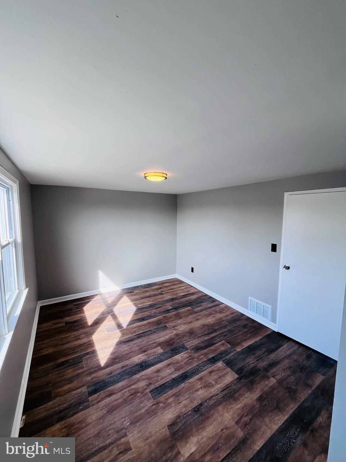 7932 Wynbrook Road Baltimore, MD 21224 - Photo 11 of 13 a room with a bed and window