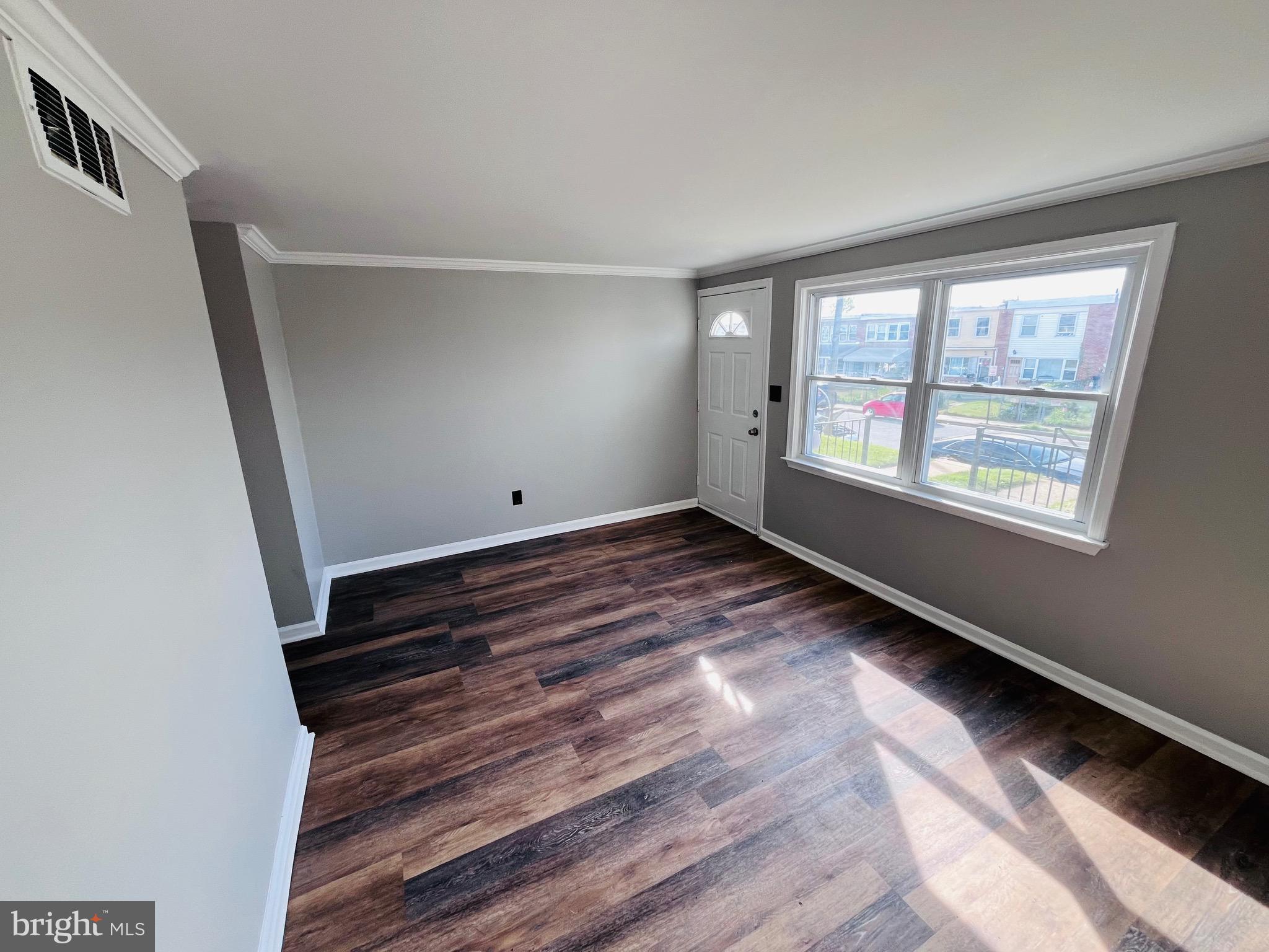 7932 Wynbrook Road Baltimore, MD 21224 - Photo 4 of 13 a view of room with window and hardwood floor