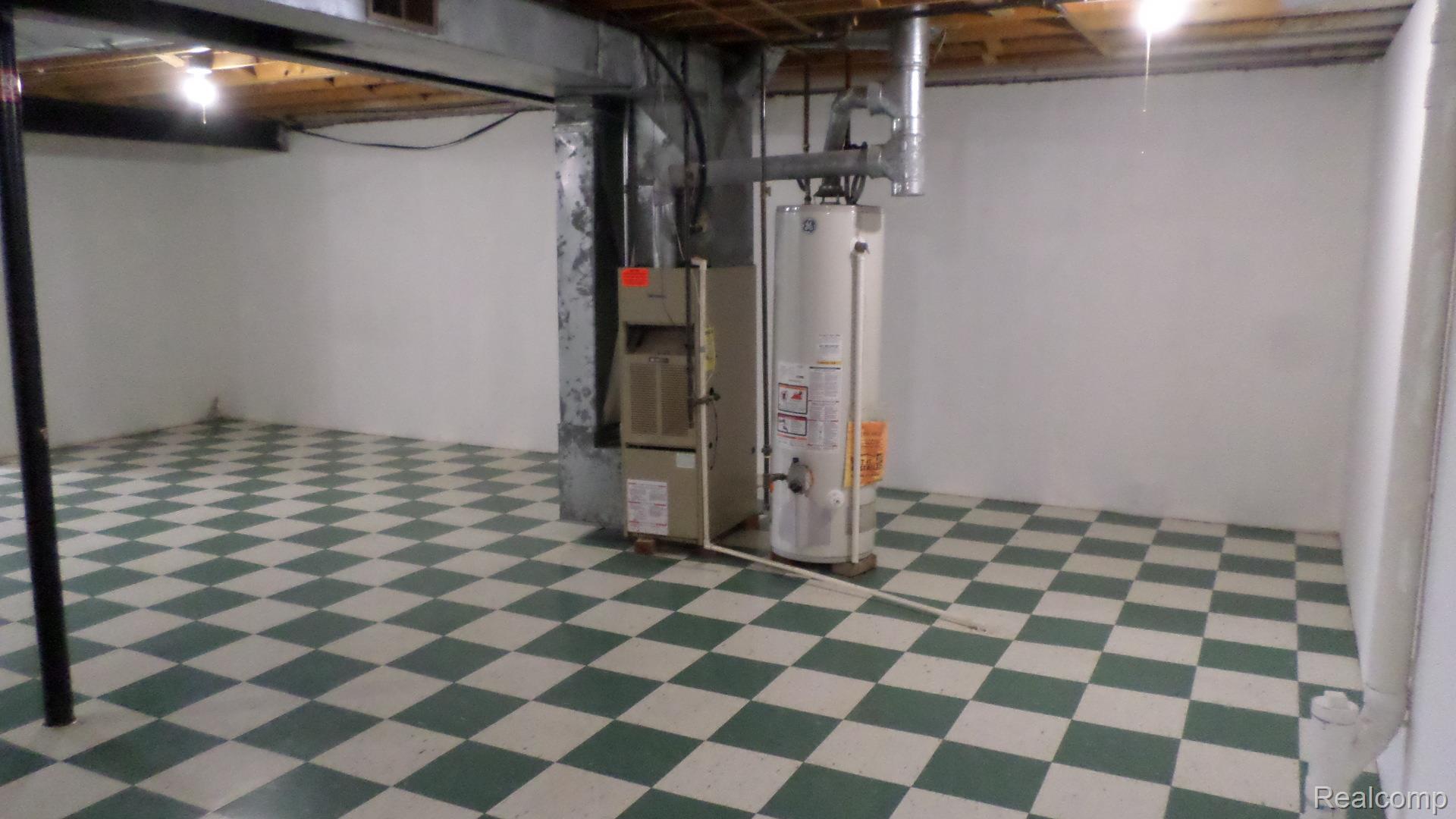 33831 Hooker Road, Unit 6 New Baltimore, MI 48047 - Photo 23 of 34 Unfinished below grade area featuring light floors, water heater, and heating unit