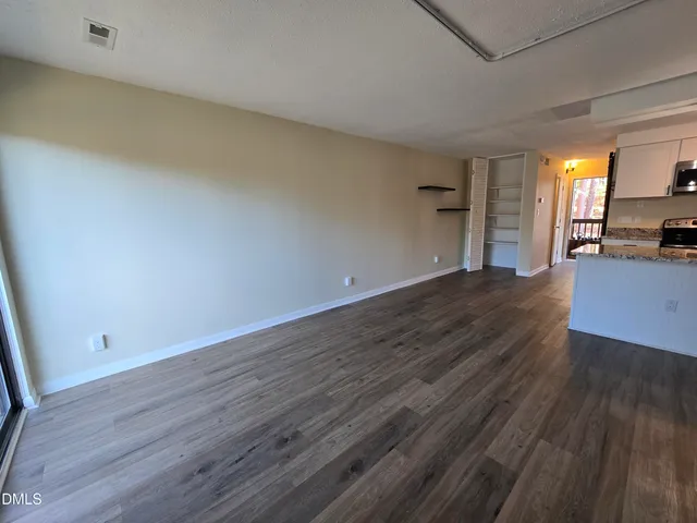a view of a room with wooden floor and a sink