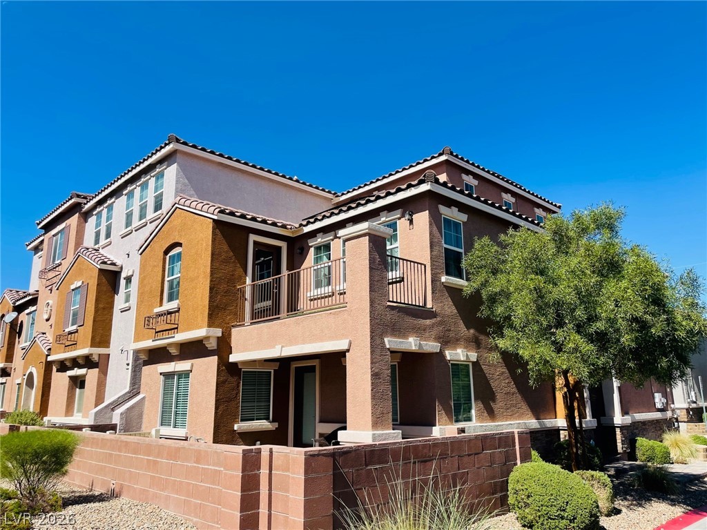 9921 Sable Point Street Las Vegas, NV 89178 - Photo 2 of 43 Mediterranean-inspired multi-level architecture features classic tile roofing and integrated private balconies.
