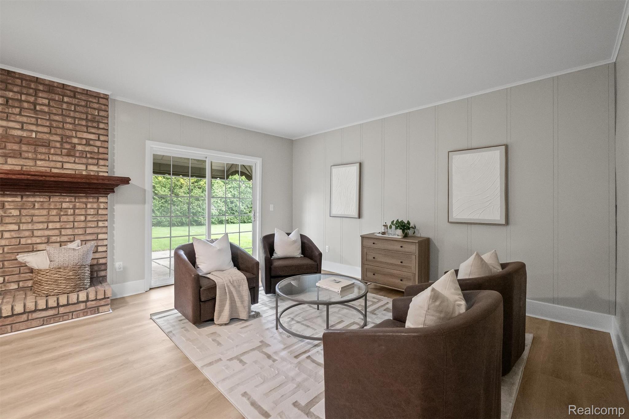 11326 Common Road Warren, MI 48093 - Photo 12 of 35 Living area with wood finished floors, crown molding, and a fireplace