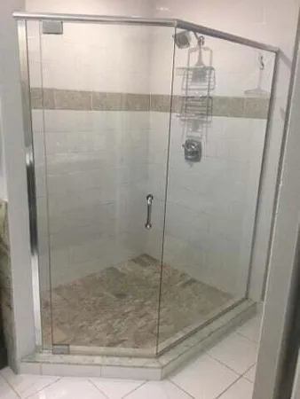 a bathroom with a glass shower door