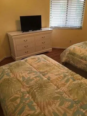 a bedroom with a bed and flat screen tv