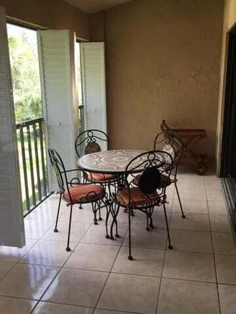 a view of a dining room with furniture and a window