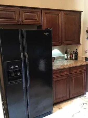 a kitchen with a refrigerator and cabinets