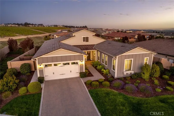 an aerial view of a house with a big yard