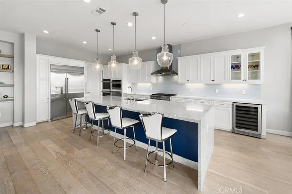 a kitchen with stainless steel appliances a refrigerator and cabinets