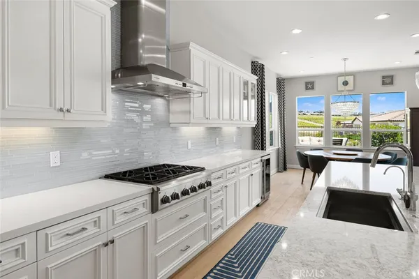 a large kitchen with stainless steel appliances kitchen island granite countertop a large center island attached withe living room