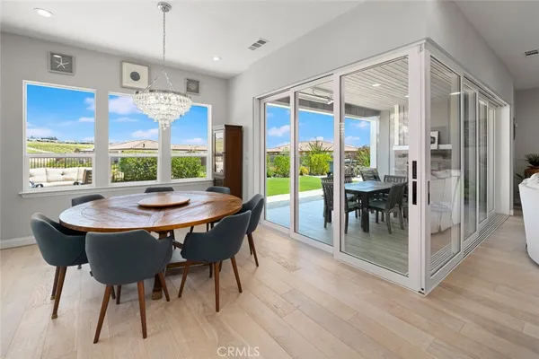 a view of a dining room with furniture window and wooden floor