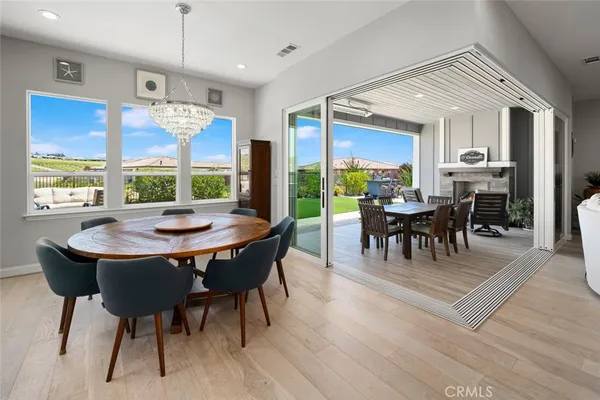 a view of a dining table and chairs in the balcony