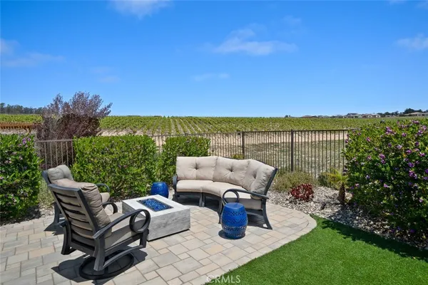 a view of a patio with lawn chairs floor to ceiling window and yard