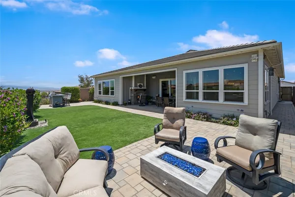 a view of a patio with table and chairs with a yard
