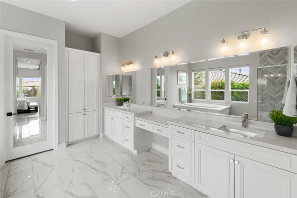 a bathroom with a granite countertop sink a mirror and a shower